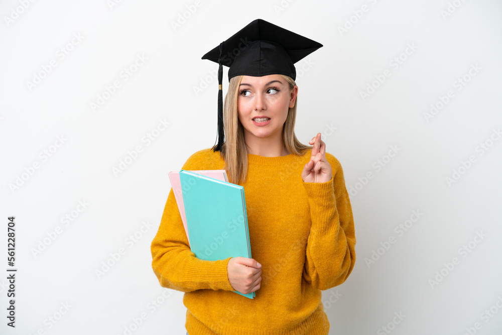 Young student caucasian woman isolated on white background with fingers crossing and wishing the best