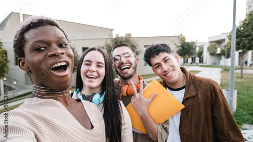 Transgender person taking a selfie with a multiethnic group of friends