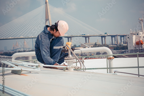 Male worker are ultrasonic thickness roof of storage tank