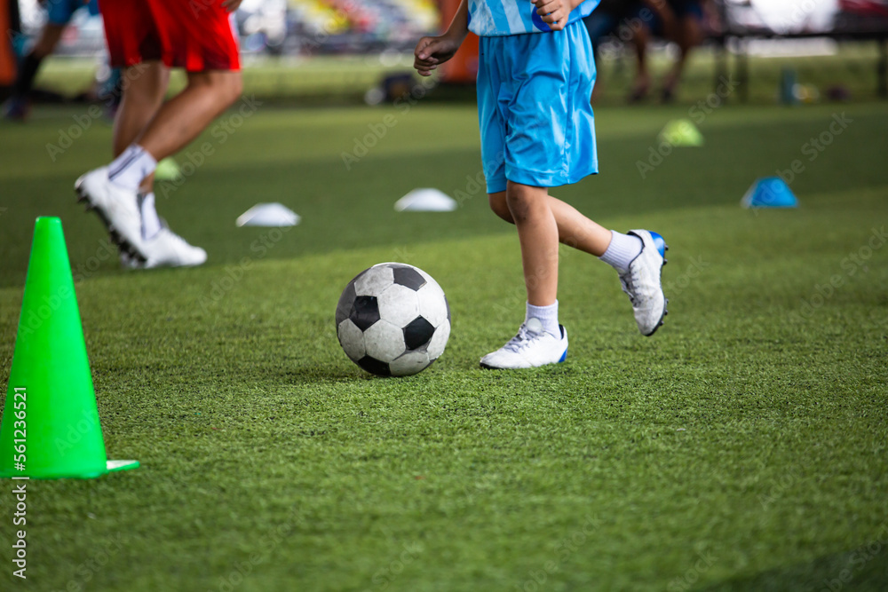 Boys Soccer ball tactics on grass field with cone Boys Soccer ball tactics on grass field with cone