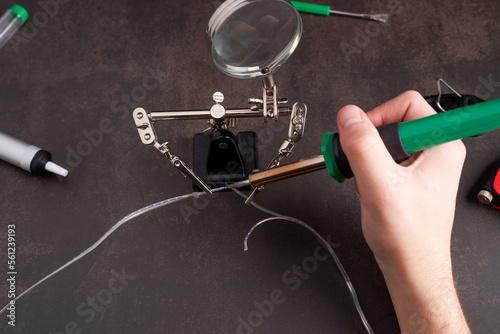 man soldering two small wires