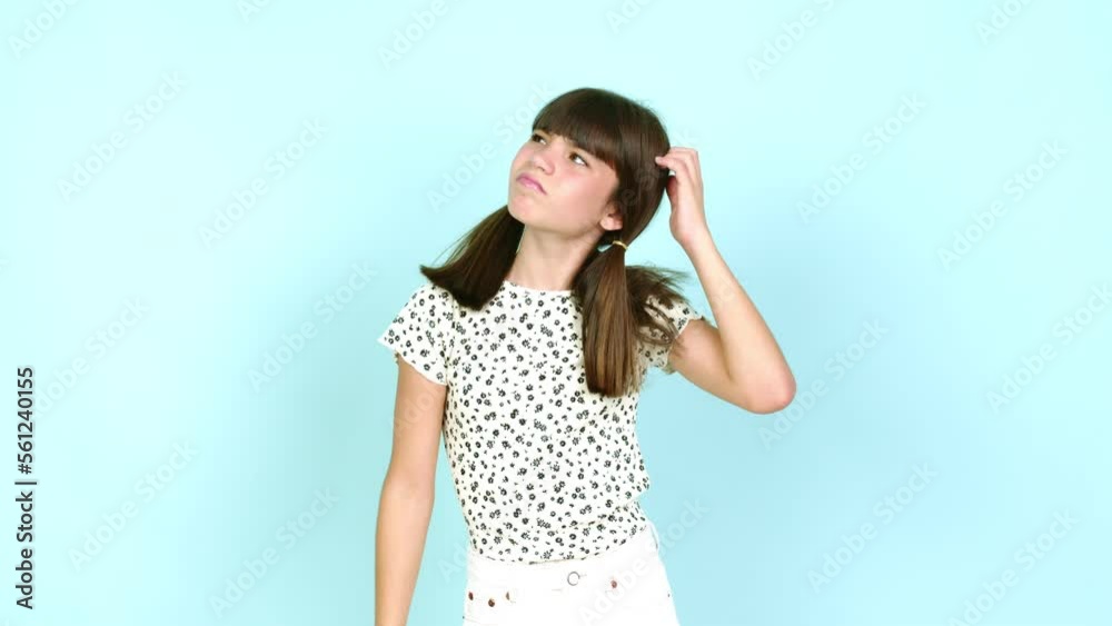Little girl having doubts while scratching head over isolated background Little girl having doubts while scratching head over isolated background
