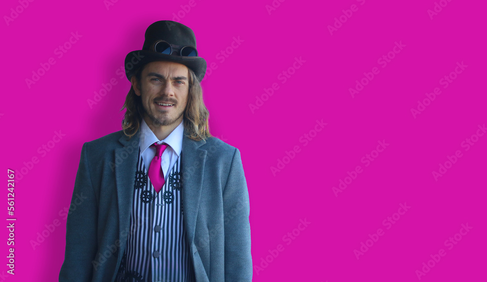 LGBTQ man in suit on pink background