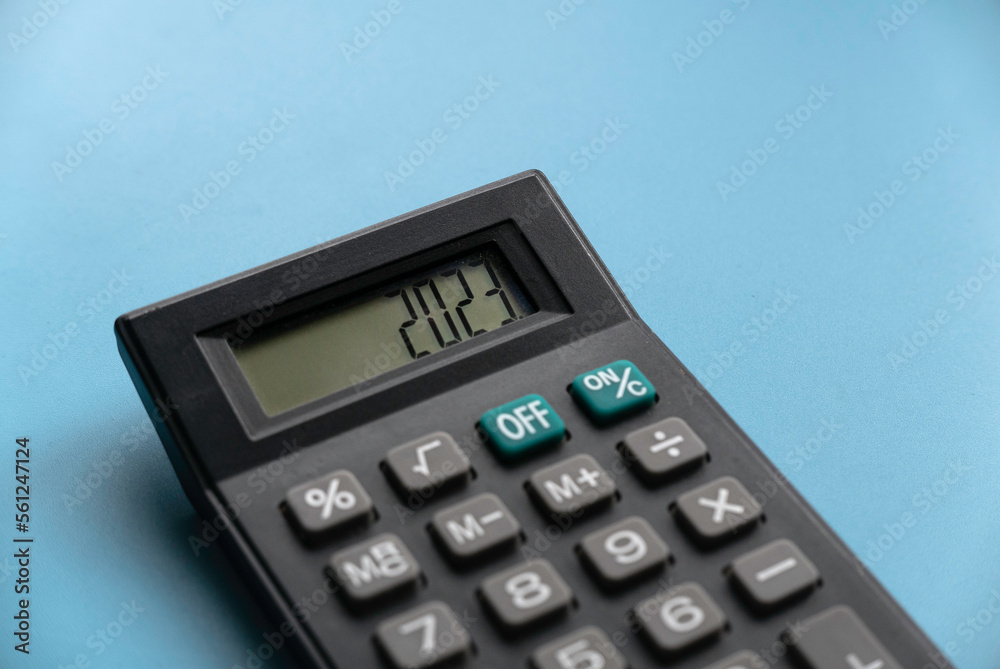 Concept of new year finance, inflation, recession, tax, budget and cost of living. Financial reminder of fiscal year 2023. 2023 on calculator screen. Concept of new year finance, inflation, recession, tax, budget and cost of living. Financial reminder of fiscal year 2023. 2023 on calculator screen.