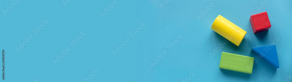 Obraz premium Education, logical thinking, business solution and creative design product concept. Colorful wooden shape on blue background. Banner with copy space.