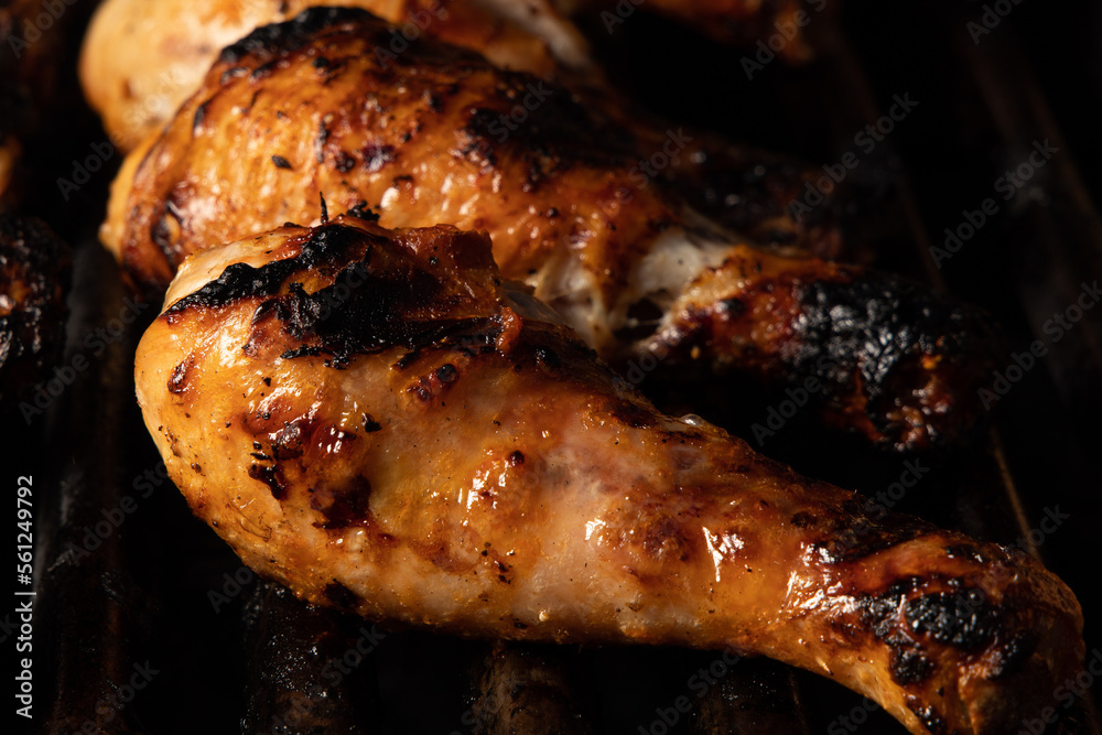 Cooked chicken drumsticks on barbecue
