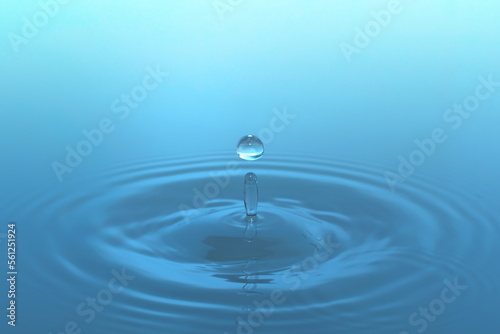 Waves of water are caused by falling droplets. close-up view.