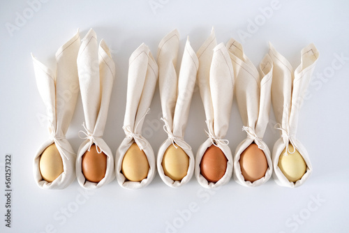 Easter background with an Easter bunny from a linen napkin and eggs.