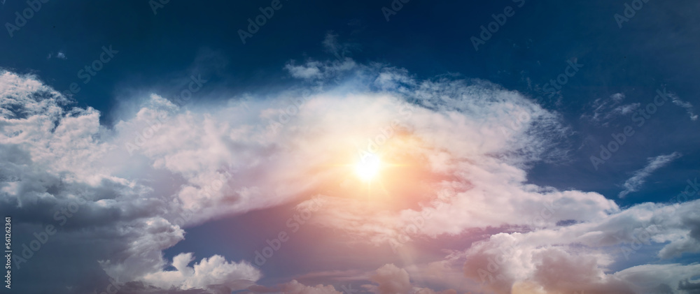 clouds in the blue sky and sunbeams