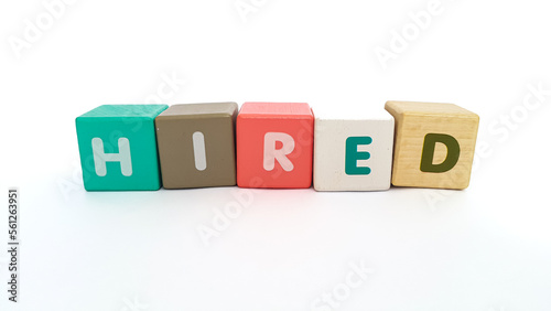 Word hired on colorful wooden cubes. Word hired on colorful wooden blocks on white background. Hired symbol.
