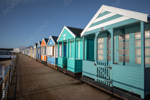 Obraz na plátně Colourful beach huts on the promonade by the pier in Southwold, Suffolk on a sum