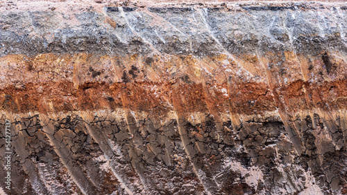Fényképezés A close-up view of the subsoil beneath a paved road that has been excavated by a backhoe