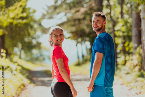 Couple enjoying in a healthy lifestyle while jogging on a country road