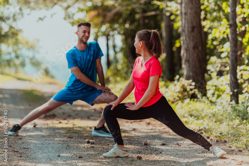 Fototapeta Naklejka Na Ścianę i Meble -  Couple enjoying in a healthy lifestyle warming up and stretching before jogging