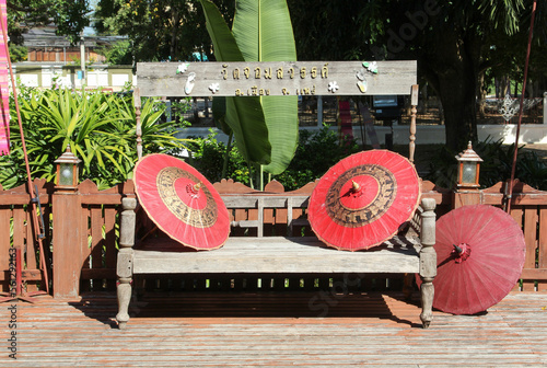 Old wooden bench on the terrace in Wat Chom Sawan, Phrae, Northern Thailand. photo