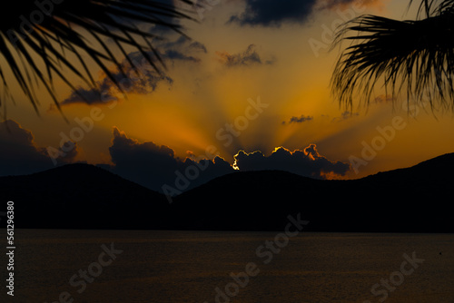 Sunset and Sunrises with silhouettes of lanterns rooftops and golden light over the sea