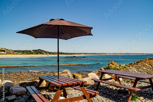 beach chairs and umbrella, L'etacq, St Ouen's Bay, Jersey, Channel Islands photo