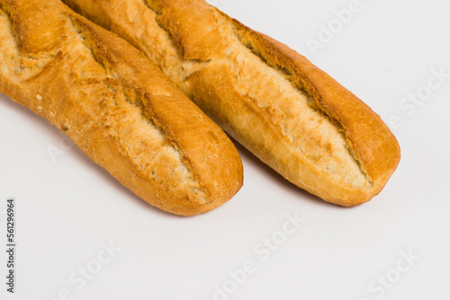 French baguettes on a white background with copy space. Delicious appetizing crust of a bun close-up
