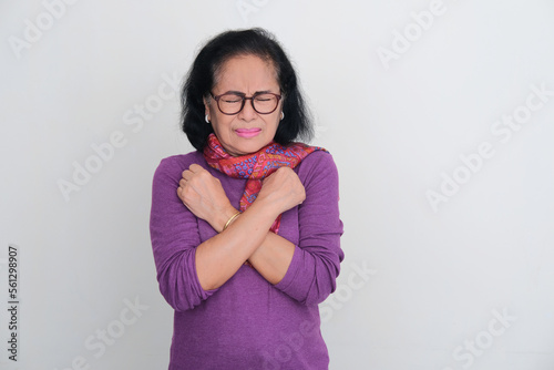 Elderly Asian woman crossing hands in her chest with scared expression photo