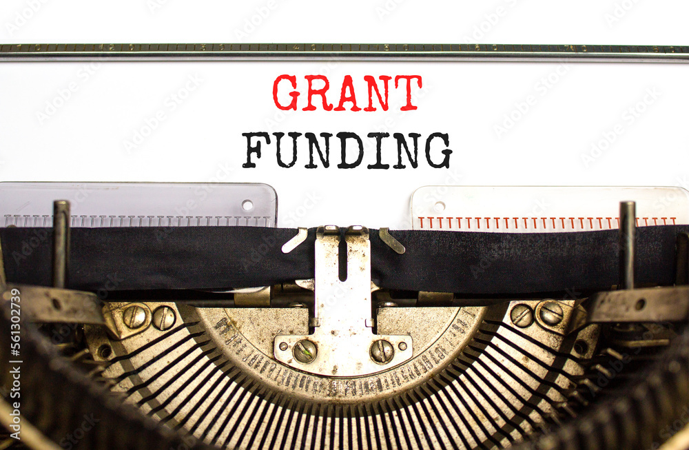 Grant funding symbol. Concept words Grant funding typed on old retro typewriter. Beautiful white background. Business and grant funding concept. Copy space.