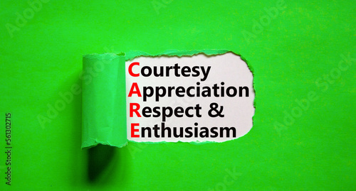CARE symbol. Concept words CARE courtesy appreciation respect and enthusiasm on white paper on beautiful green background. Business CARE courtesy appreciation respect enthusiasm concept. Copy space.