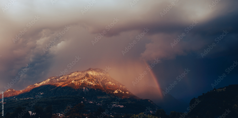 Storm front over the Alps mountains in Switzerland. Rain clouds and rainbow. Storm front over the Alps mountains in Switzerland. Rain clouds and rainbow.