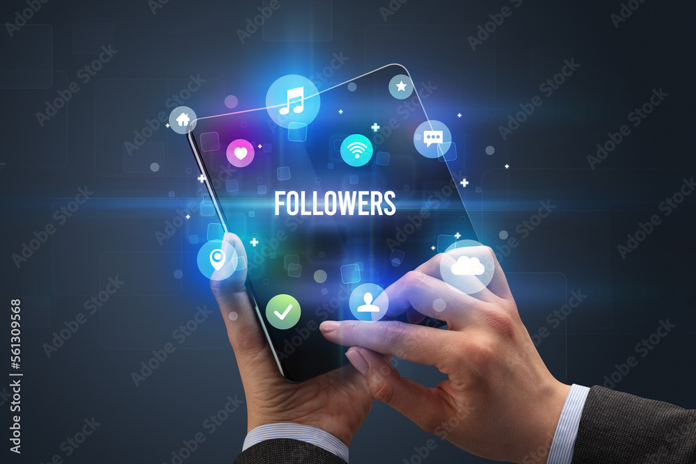 Businessman holding a foldable smartphone Businessman holding a foldable smartphone