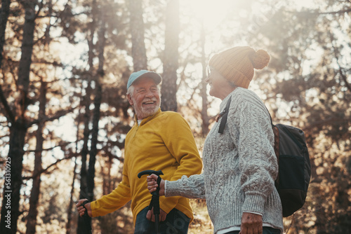 Portrait close up head shot of one cheerful smiling middle age woman walking with her husband enjoying free time and nature. Active beautiful seniors in love together at sunny day.