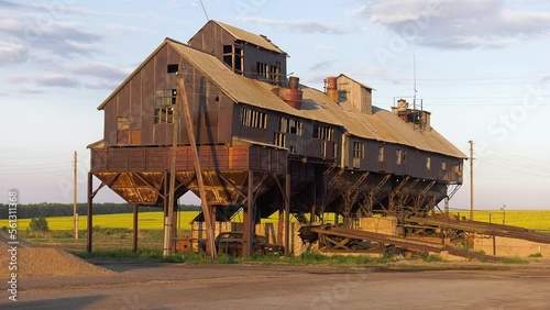 Volga region, harvest season. Mechanized threshing floor at the sunset light. photo