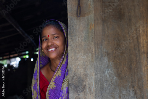 Rural woman standing at door of house in indian village