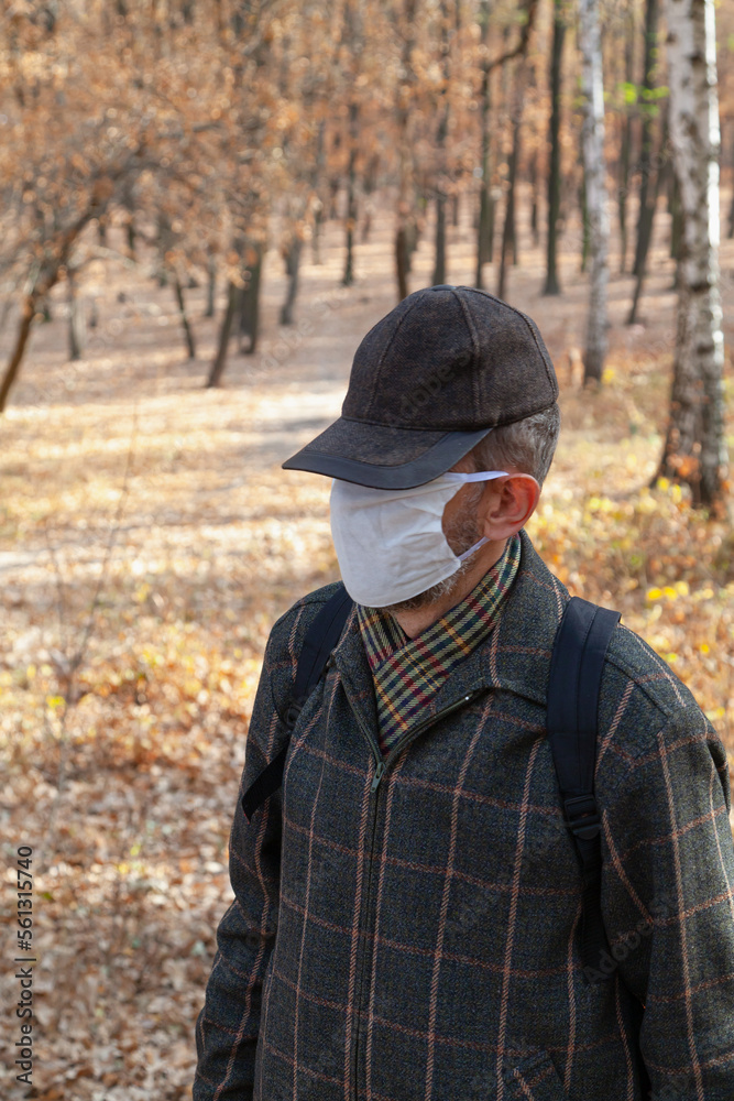 Man in cap and protective mask in nature Man in cap and protective mask in nature