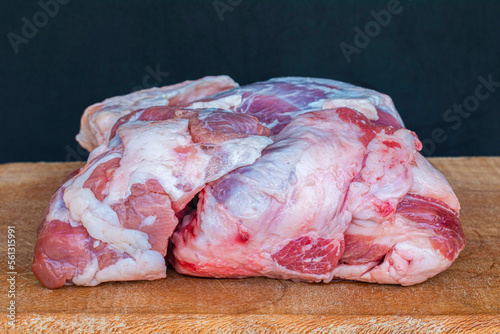 Raw mutton on wood. Meat concept photo on dark background.