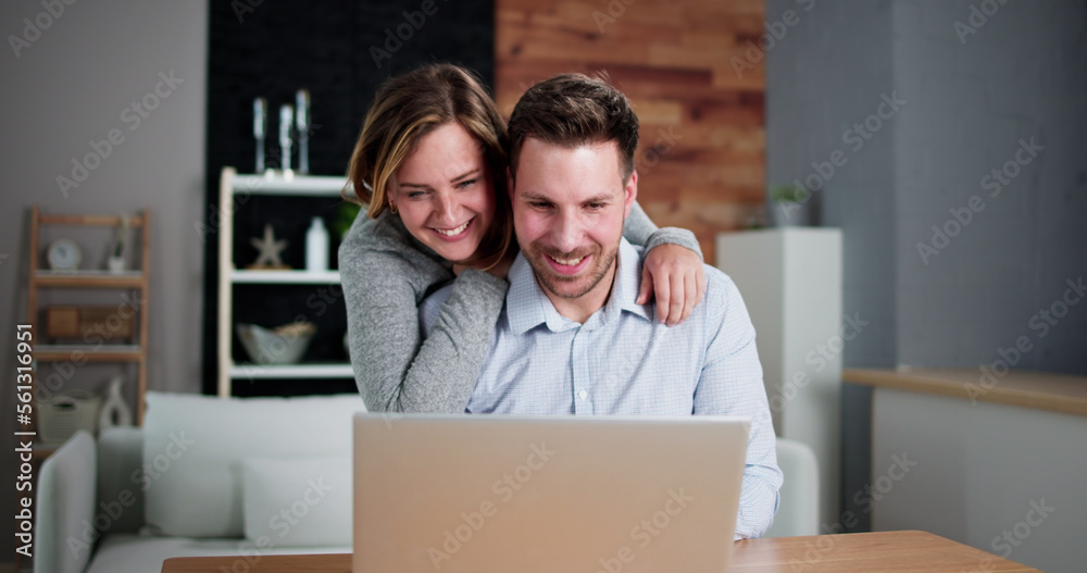 Happy Couple Looking At Laptop Happy Couple Looking At Laptop
