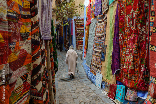 North Africa. Morocco. Chefchaouen. An old man dressed in a djellaba walking in a street of the medina photo