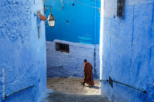 North Africa. Morocco. Chefchaouen. An old man dressed in a djellaba walking in a street of the medina