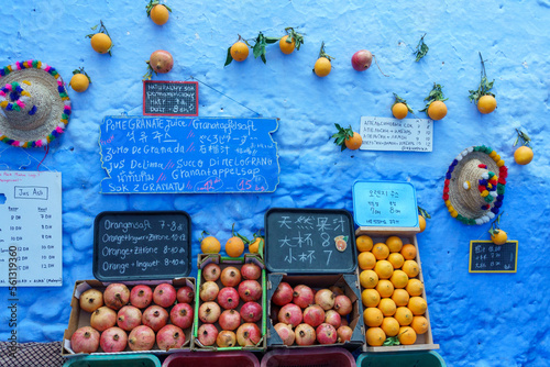 North Africa. Morocco. Chefchaouen. Fruits for sale in front of a decorated blue wall photo