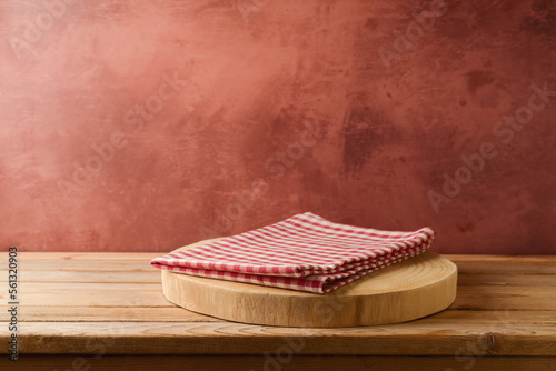 Wooden log with tablecloth on table over rustic wall  background. Kitchen interior mock up for design and product display