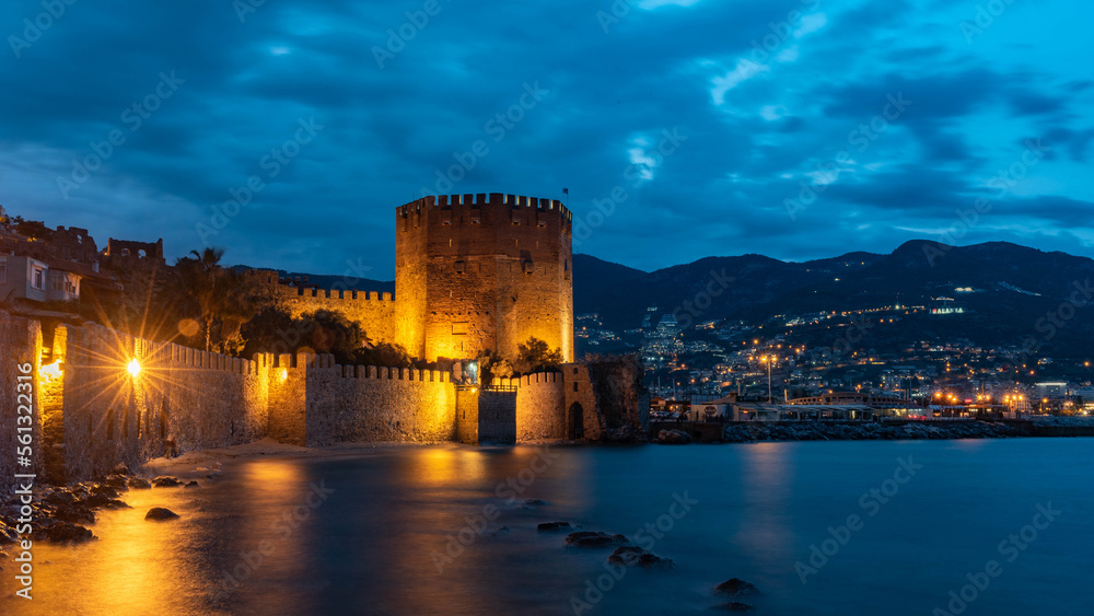 Alanya, Turkey, April 9th 2021 .Stunning panorama of Alanya Harbour and the Red Tower at night with the Taurus Mountains and Mediterranean Sea, Turkey. .