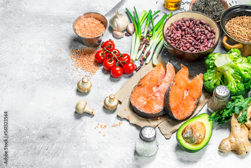 Organic food. Assortment of heathy food with raw salmon steaks .