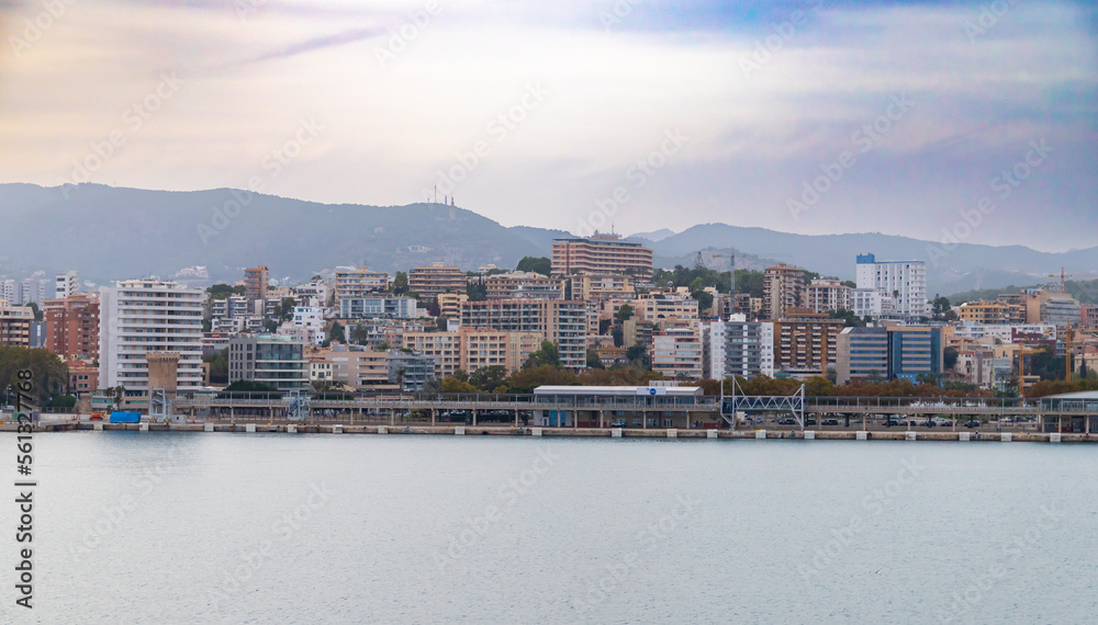 Naklejka premium Mallorca, Spain - October 22, 2022, Port Alcudia in the early evening, view of the city from the sea in Mallorca