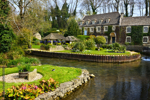 Garden and ponds in the picturesque Cotswolds village of Bibury, England photo