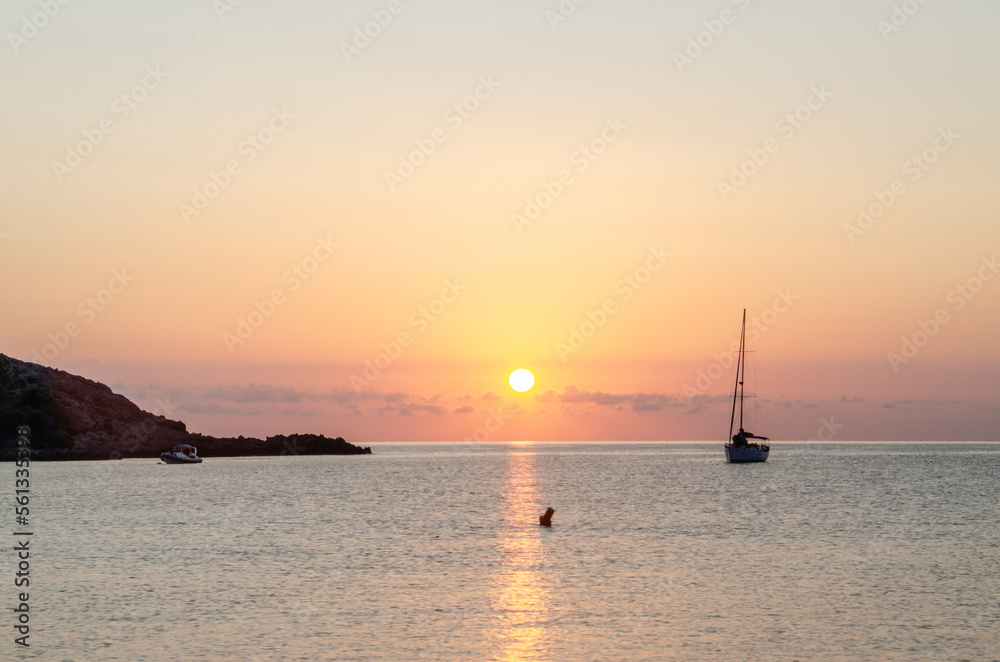 sea dawn with yacht silhouette