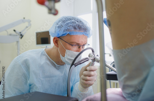 a proctologist examines a rectal colonoscopy patient lying on a medical chair in the surgical office. Rectal examination. photo