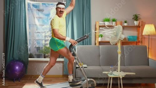 funny athlete pours water on himself running treadmill in the living room