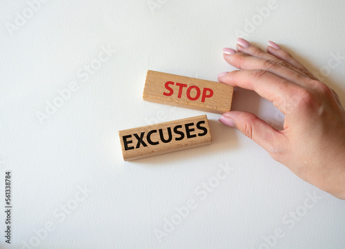 Stop excuses symbol. Concept words Stop excuses on wooden blocks. Businessman hand. Beautiful white background. Business and Stop excuses concept. Copy space.