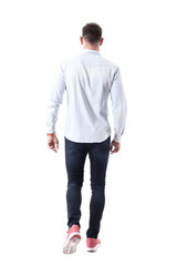 Back view of handsome elegant business man in sneakers walking away and looking ahead. Full body isolated on transparent background.