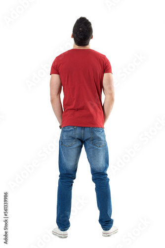 Back view of young casual man with hands in pockets looking up. Full body length portrait isolated over transparent background