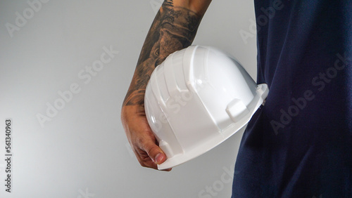 construction helmet in the hand of man photo