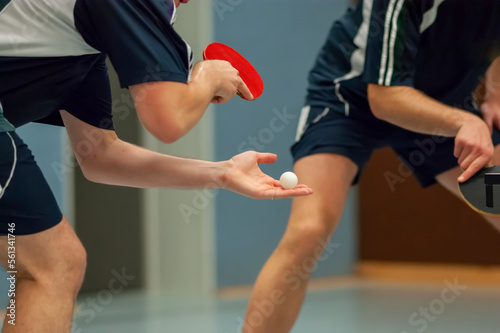 Table Tennis Player serving, holding ball in hand 