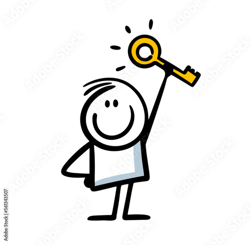 Happy boy holds a golden key to the door in his raised hand.